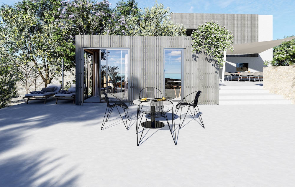 Studio de jardin habitable bardage bois grisé grandes baies vitrées terrasse extérieure mobilier de jardin