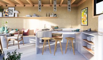 Cuisine lumineuse dans un studio de jardin avec des tabourets en bois et une banquette confortable