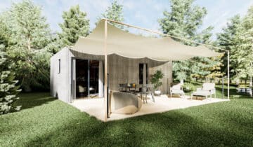 Studio de jardin en bois avec terrasse aménagée sous voile d'ombrage dans un environnement verdoyant